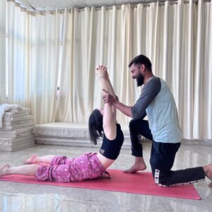 Yoga Teacher Training Rishikesh - Teacher Assisting Upward Facing Dog